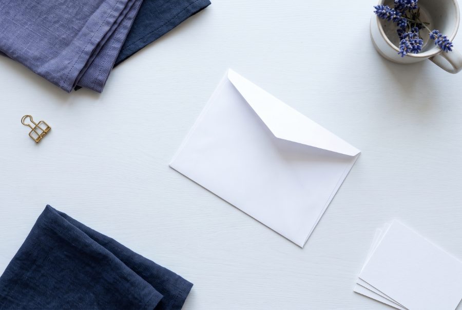 A plain white envelope resting on a pale desk